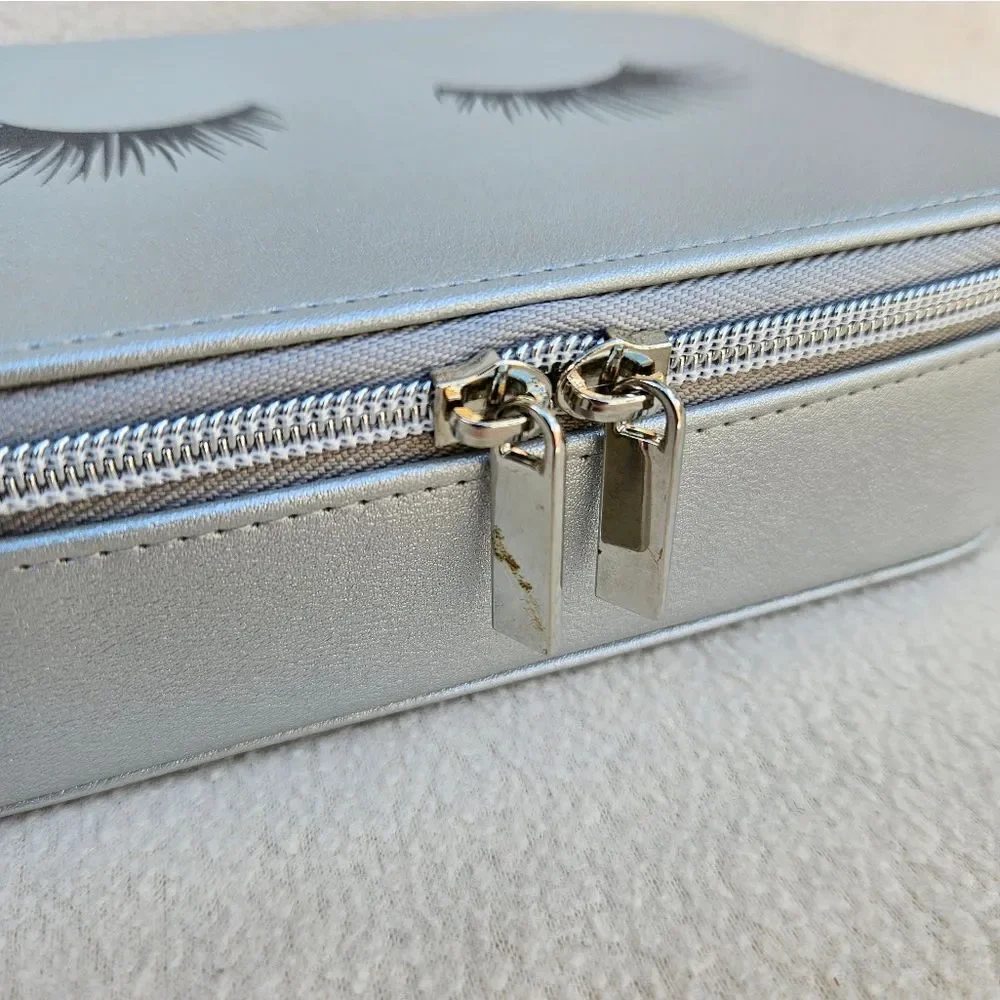 Neiman Marcus Silver Cosmetic Case with Eyelashes on the Front